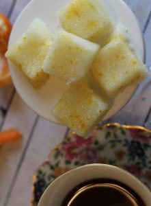 maple orange sugar cubes on plate by tea