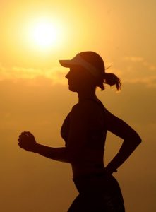 girl running with sunrise behind her